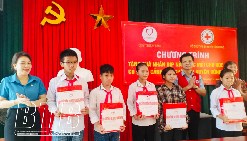 Đại diện Hội Chữ thập đỏ huyện, Liên đoàn Lao động huyện Đông Hưng trao quà cho học sinh có hoàn cảnh khó khăn.